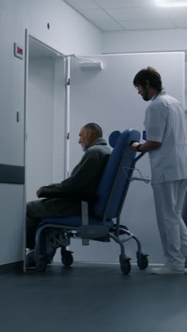 doctor transports patient on wheelchair in cabinet 4k 2025 07 22 10 39 15 utc.mov | assistance, care, caucasian, clinic