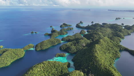 high-quality drone shot hovering and revealing the crystal blue waters and islands of palau. panning wide drone shot