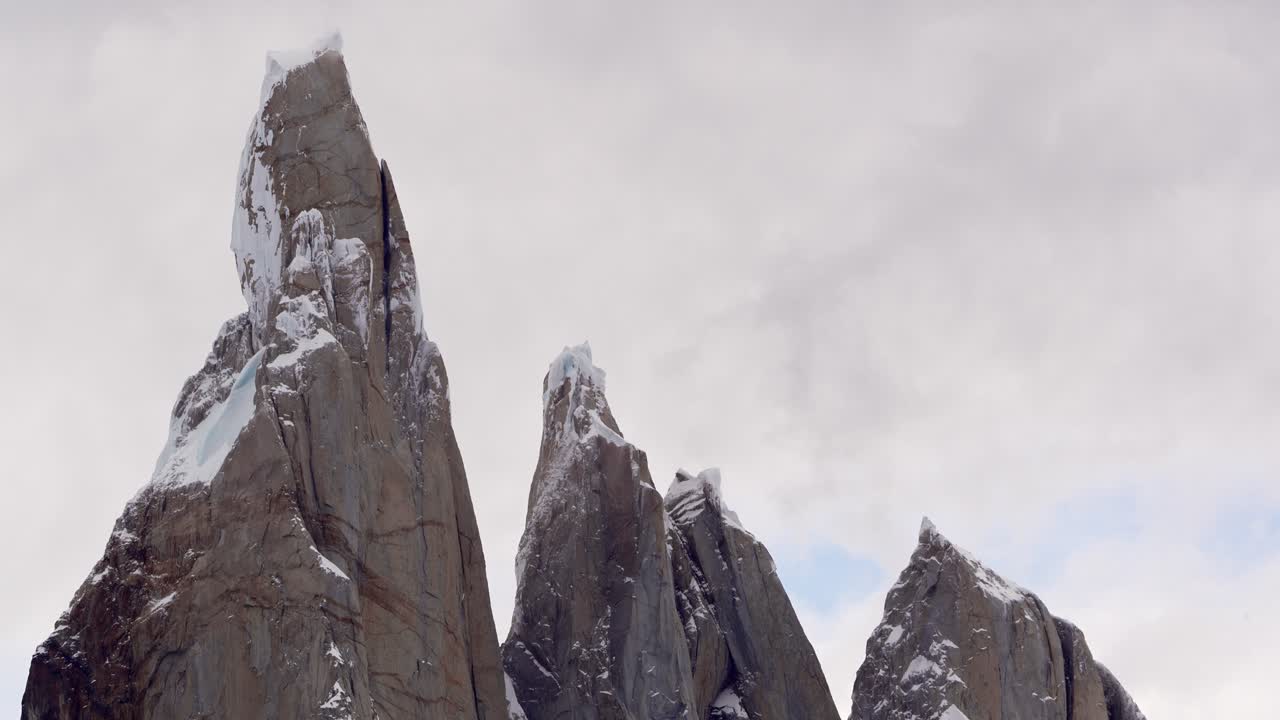 Up close establishing view of Cerro Torre summit in Patagonia, Argentina, El Chalten on a snowy winter cloudy day