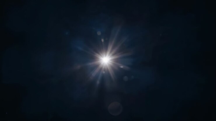 Singolo punto a forma di stella che si apre formando un effetto starburst su vuoto nero, lens flare in evoluzione dal nucleo
