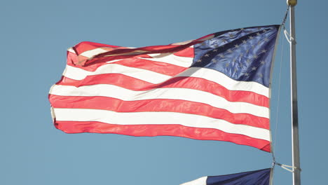 Medium-shot-of-United-States-stars-and-stripes-American-flag-flapping-in-wind