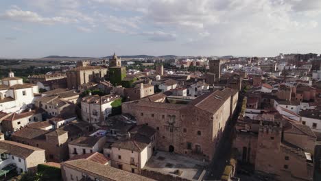 Cinematic-aerial-pull-out-shot-of-Caceres,-medieval-old-town