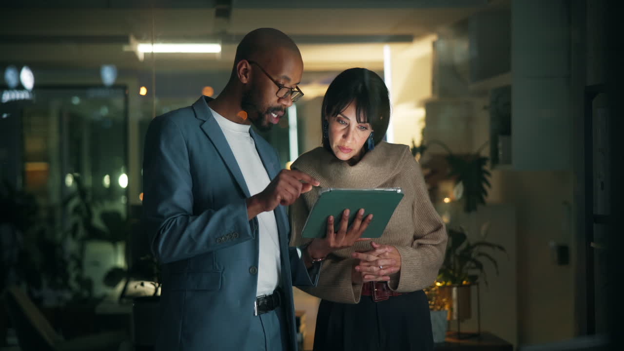 Business colleagues discussing work on a tablet