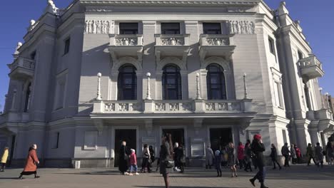 exterior of a beautiful historical opera house with people walking