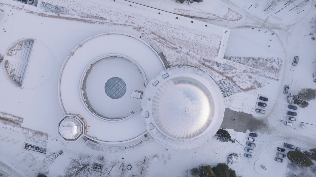 Drone shots of Silesian Park in winter, featuring the Silesian Planetarium. Top shot.