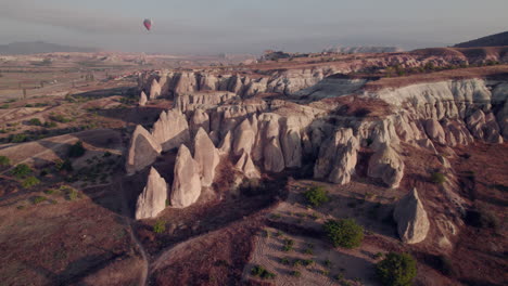 aerial view of cappadocia’s fairy chimneys and balloons