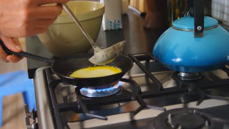 man preparing pancakes in kitchen at home 4k