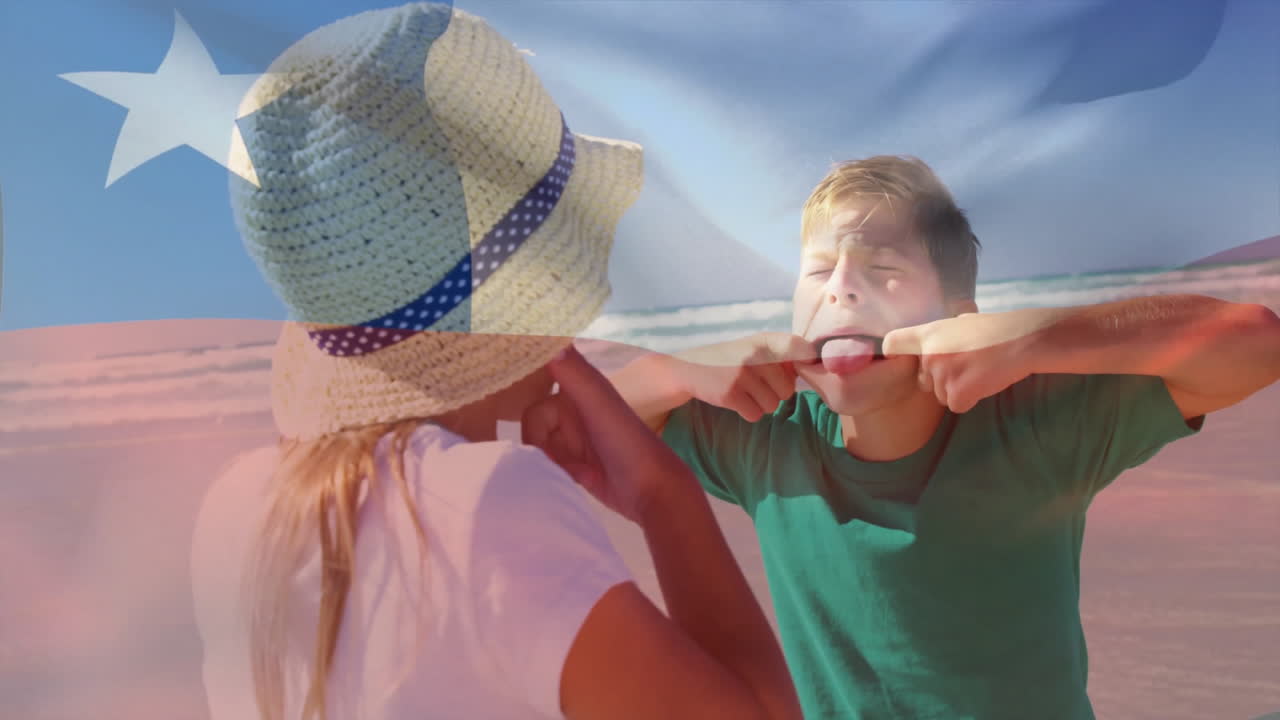 At beach, two children making funny faces with Chilean flag animation overlay