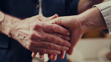 close-up of hands connecting and shaking