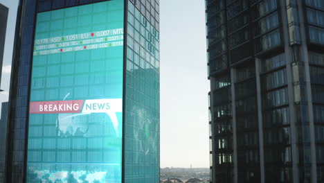 Modern-high-rise-office-buildings-in-business-hub.-Breaking-news-and-financial-figures-projected-on-facade.-Aerial-ascending-shot-in-Frankfurt-am-Main,-Germany