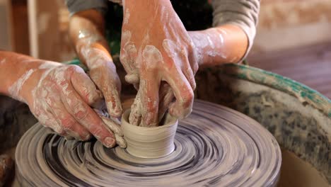 female potter assisting a girl