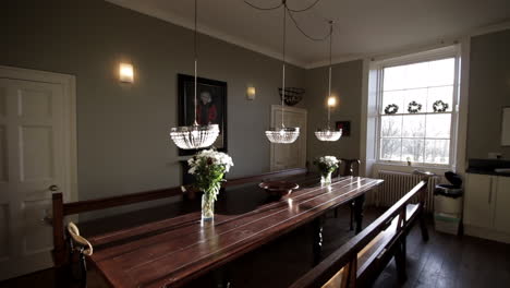 large kitchen banquet table with crystal pendant lights