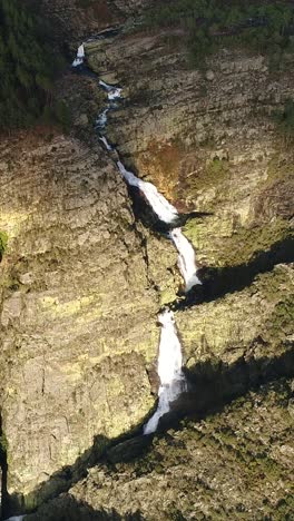aerial view of a stunning waterfall cascading down rocky cliffs
