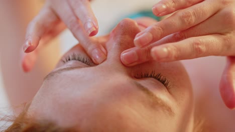 Close-up-of-a-beautiful-young-woman-lies-in-bed-and-rubs-her-eyes