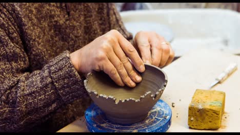 Potter-carving-on-earthenware-bowl