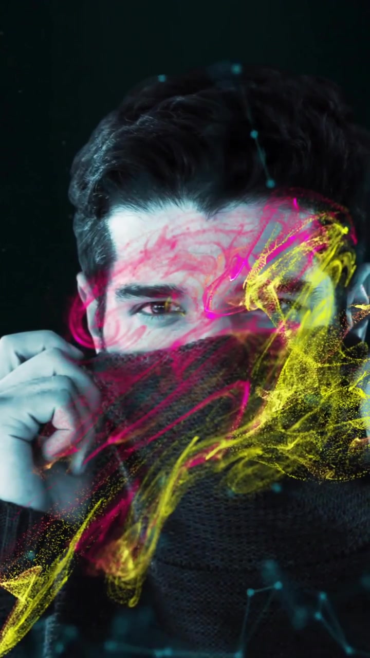 Man adjusting scarf with colorful abstract animation overlay on dark background