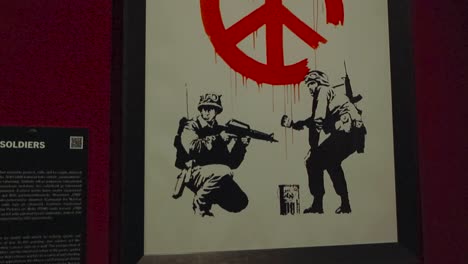 banksy's soldiers painting a peace sign: a powerful commentary on war and peace