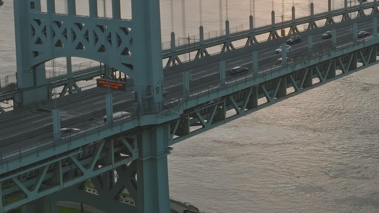 View of the bridge and traffic in New York at sunset over the water