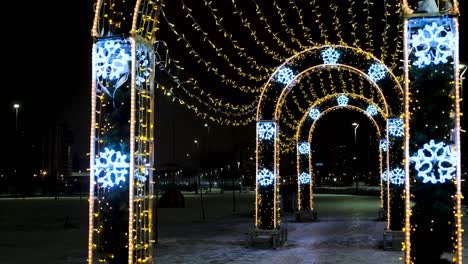 illuminated winter archway in a park at night