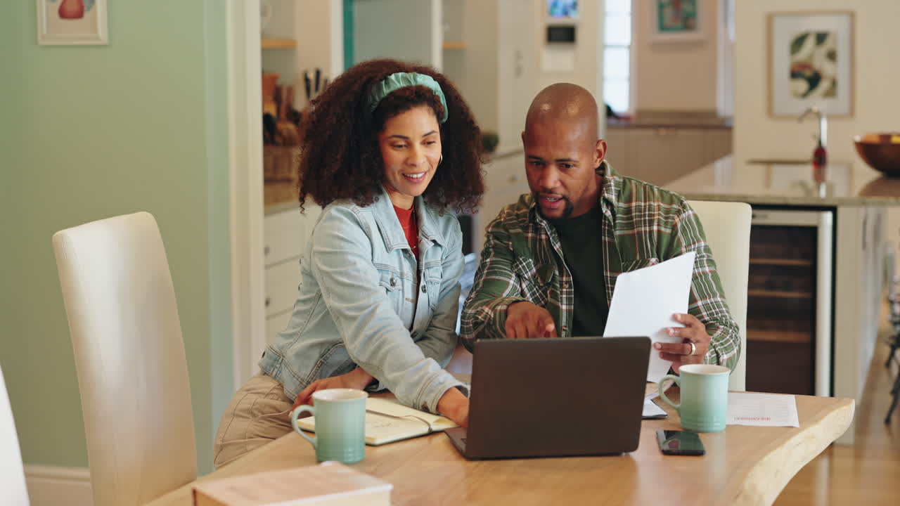 Couple working together at home on finances
