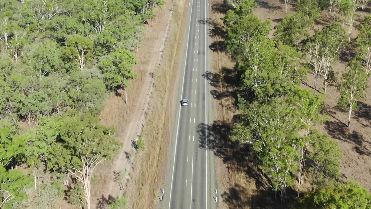 Isolated car driving on deserted road at st lawrence, clairview in ...