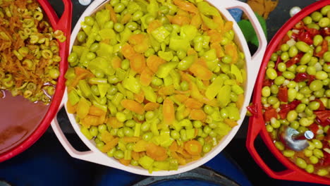 top view of pickled olives in buckets selling on the market in algeria, ghardaia