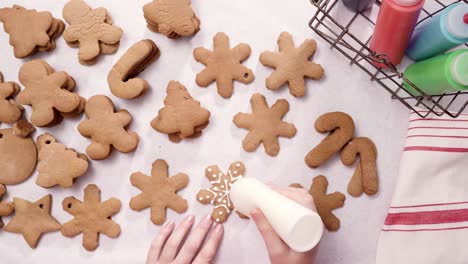 decorating gingerbread cookies with royal icing for christmas.