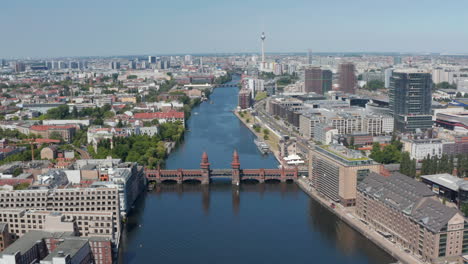 Tilt-down-footage-of-Oberbaum-bridge.-High-angle-view-of-historic-double-deck-bridge-over-Spree-river.-Berlin,-Germany
