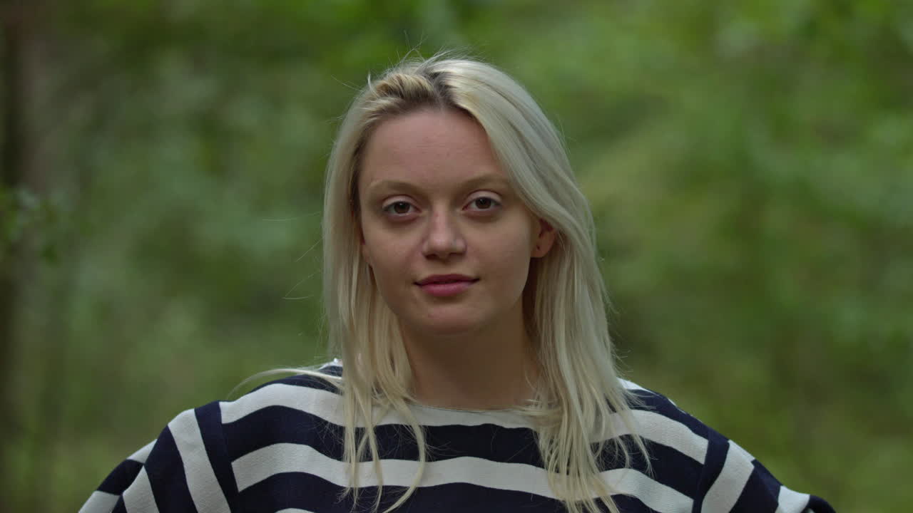 Natural pretty girl posing in front of camera and smiling,outdoor in forest