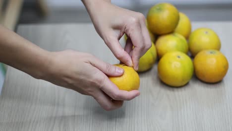 sequential frames showing the process of peeling an orange