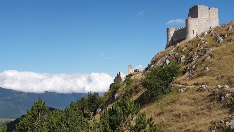 pan right of rocca calascio montaintop fortress and appenines mountain range, italy