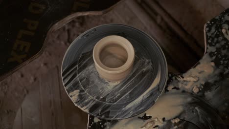 the potter makes a jug of clay. ceramist. a man makes a vase on a potter's wheel