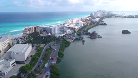 Aerial-view-of-Cancun-hotel-zone-between-blue-Caribbean-Sea-and-Nichupté-Lagoon-with-tourist-activity,-Mexico