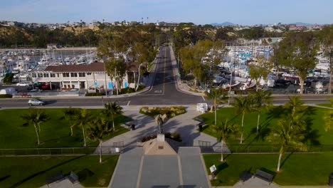 aerial dolly along magnificent ocean side road intersection and harbor