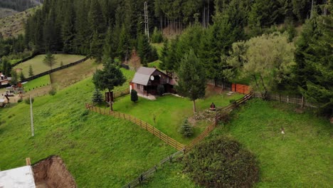 countryside scene with cabins near the forest mountains