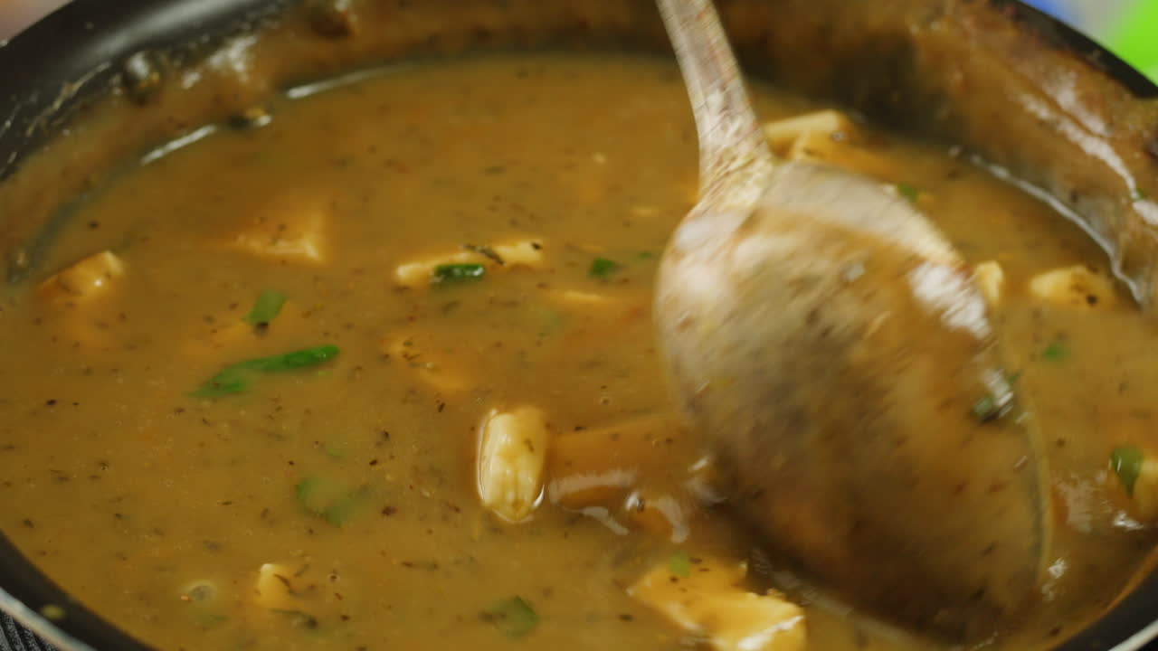 Cooking traditional Indian meal Palak Panir with spinach and cheese close up. Palak paneer is an Indian dish, consisting of paneer in a thick paste made from pureed spinach, Palak paneer is prepared by first boiling and pureeing spinach.