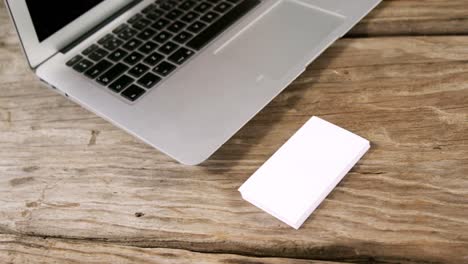 Laptop-and-stack-of-business-cards