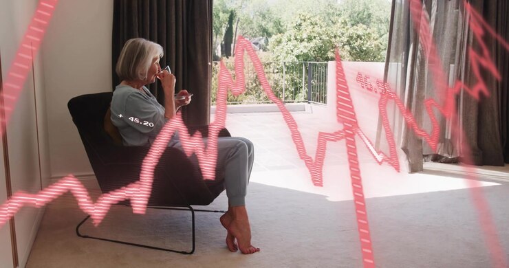 Woman lifting mug while activating red line graph sweeping behind illustrating finance trends