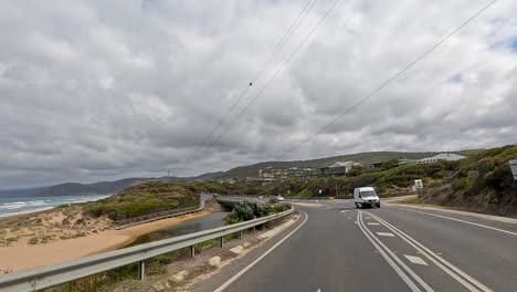 a 45-second journey capturing the coastal beauty and winding roads of great ocean road, australia, under overcast skies