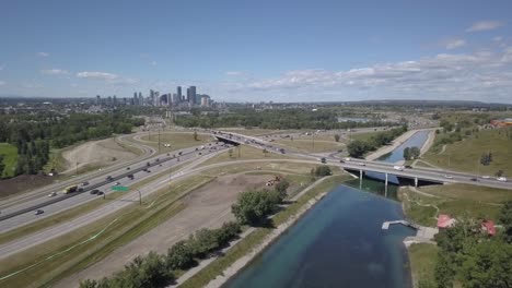 city skyline with freeway traffic and canal