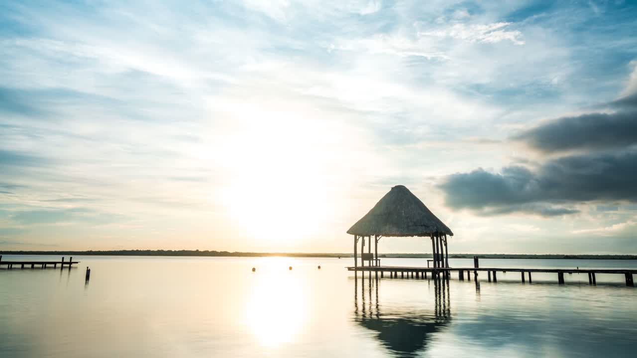 Mexico Time lapse Palapa on lake Bacalar Quintana Roo cloudy blue sky Sunrise Sunset tourism Cancun Tulum
