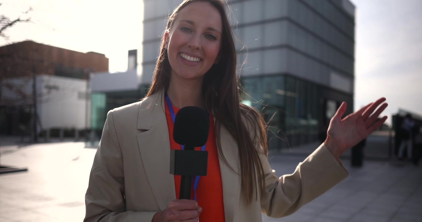 Female Reporter Reporting Live Outside Modern Office Building