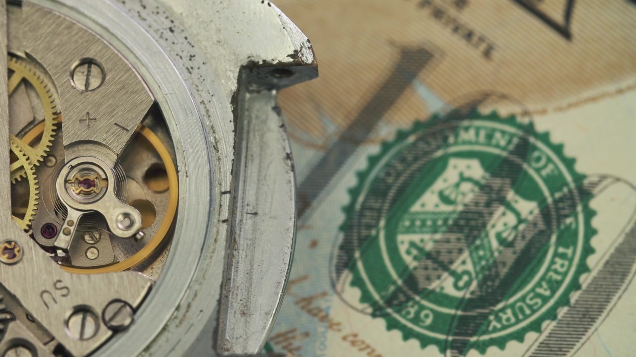 Close-up of Mechanical Watch Movement Ticking Over US Currency