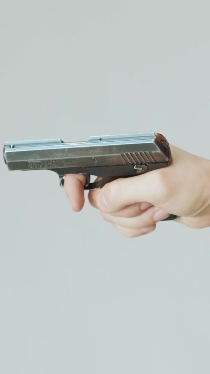 Close-up of Hand Racking Slide on a Small Pistol