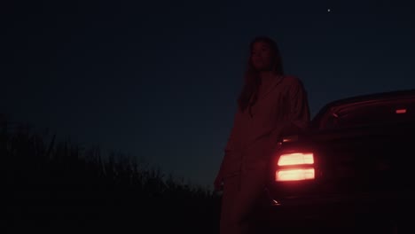 woman by car at night