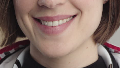 close-up-beautiful-woman-mouth-smiling-soft-lips-showing-healthy-white-teeth