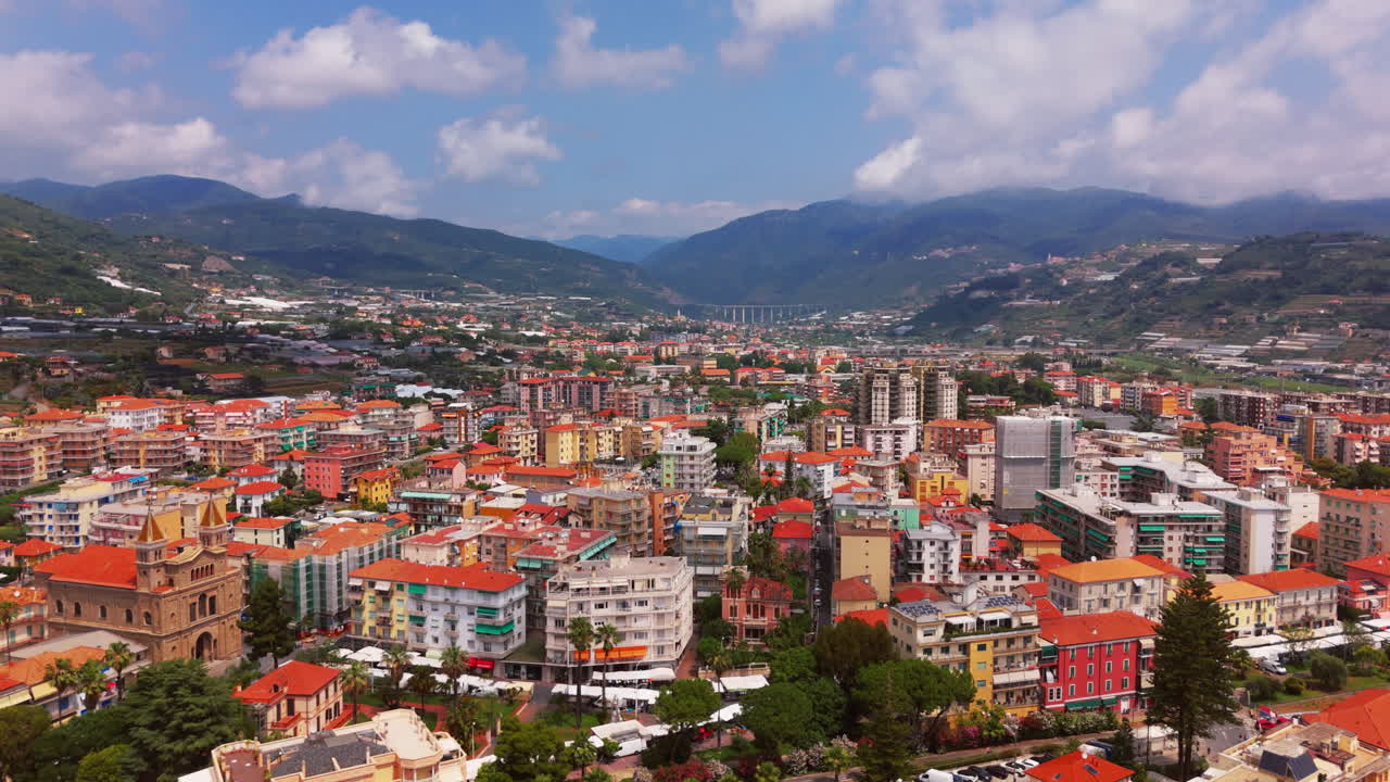 Beautiful view of Liguria city, Italy with rooftops, buildings, and surrounding mountains