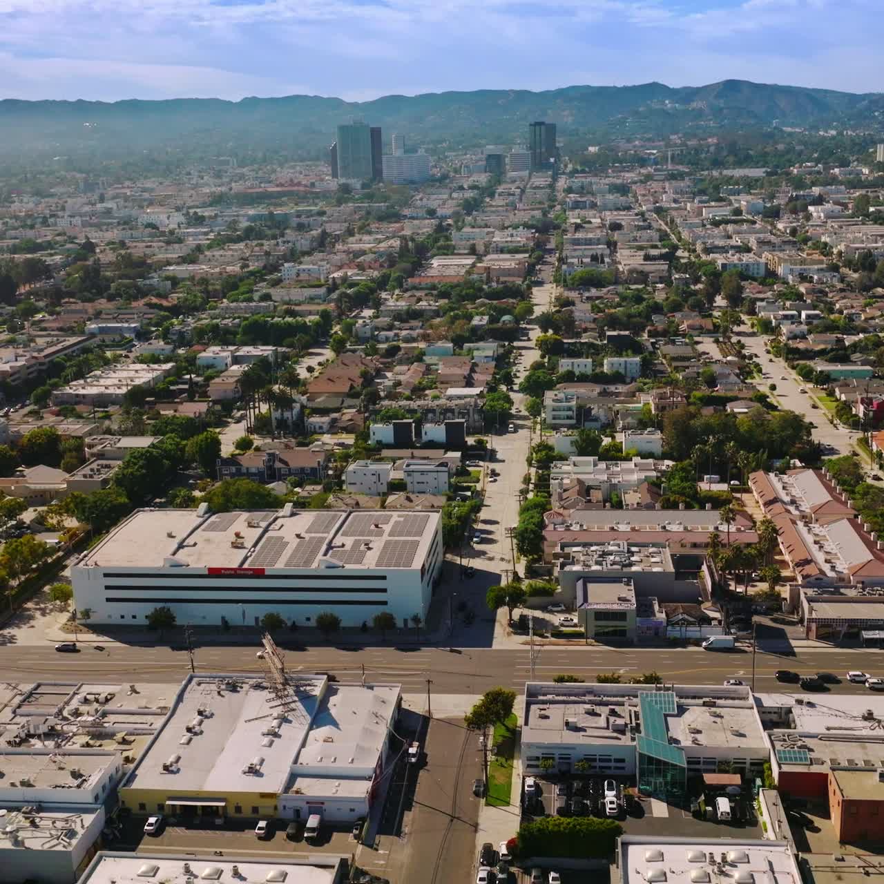 Sunny streets of urban modern Los Angeles at daytime. Lively city of California, USA from aerial perspective
