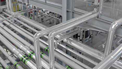 rows of silver insulated pipes inside industrial facility, showcasing complex engineering, castets, france