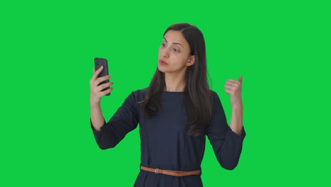 indian girl talking on video call green screen